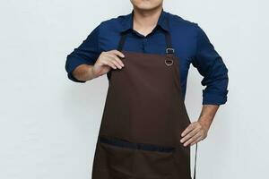 Asian Man wearing Apron in casual stylish clothing, standing upright pose while wearing and tidying his apron, no face isolated white background photo