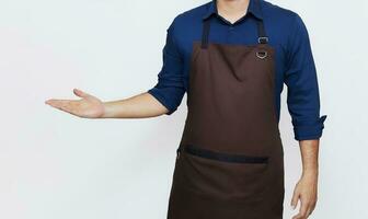 Asian Man wearing Apron in casual stylish clothing, standing tall hospitality pose with one hand showing something, no face isolated white background photo