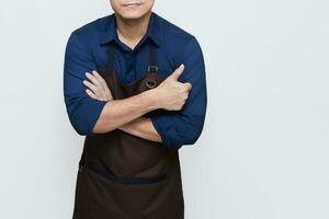 Asian Man wearing Apron in casual stylish clothing, standing upright pose with folded hands and one hand giving a thumbs up, no face isolated white background photo