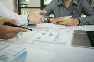Asisan businessman teamwork meeting and discussing the investment data and report graph. photo