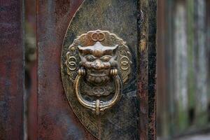 Dragon head door knocker, close up. Antique Chinese handle knocker. photo