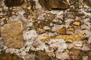 Ancient stone wall fragment. Abstract weathered background. photo