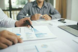Asisan businessman teamwork meeting and discussing the investment data and report graph. photo