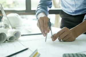 Engineer, architect working using compass. photo