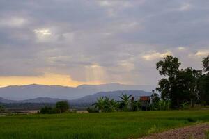 Inspirational landscape of distant ridge and agricultural fields in valley. Beautiful tropical scenery. photo