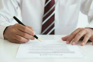 Close up businessman signing contract, partnership agreement, making deal photo