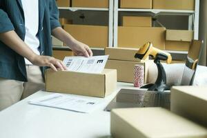 Young entrepreneur packing online order product for shipping. photo