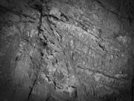 Black stone background. Long black stone texture and textured. Dirty black stone wall. Rock texture with cracks. stone tile floor texture. Old wall texture abstract natural background. photo