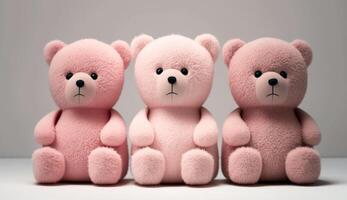 three pink teddy bears sitting next to each other on a table. . photo