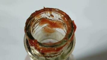 The top of the sauce bottle that has the rest of the sauce is messy and some of it is starting to turn black in color. video