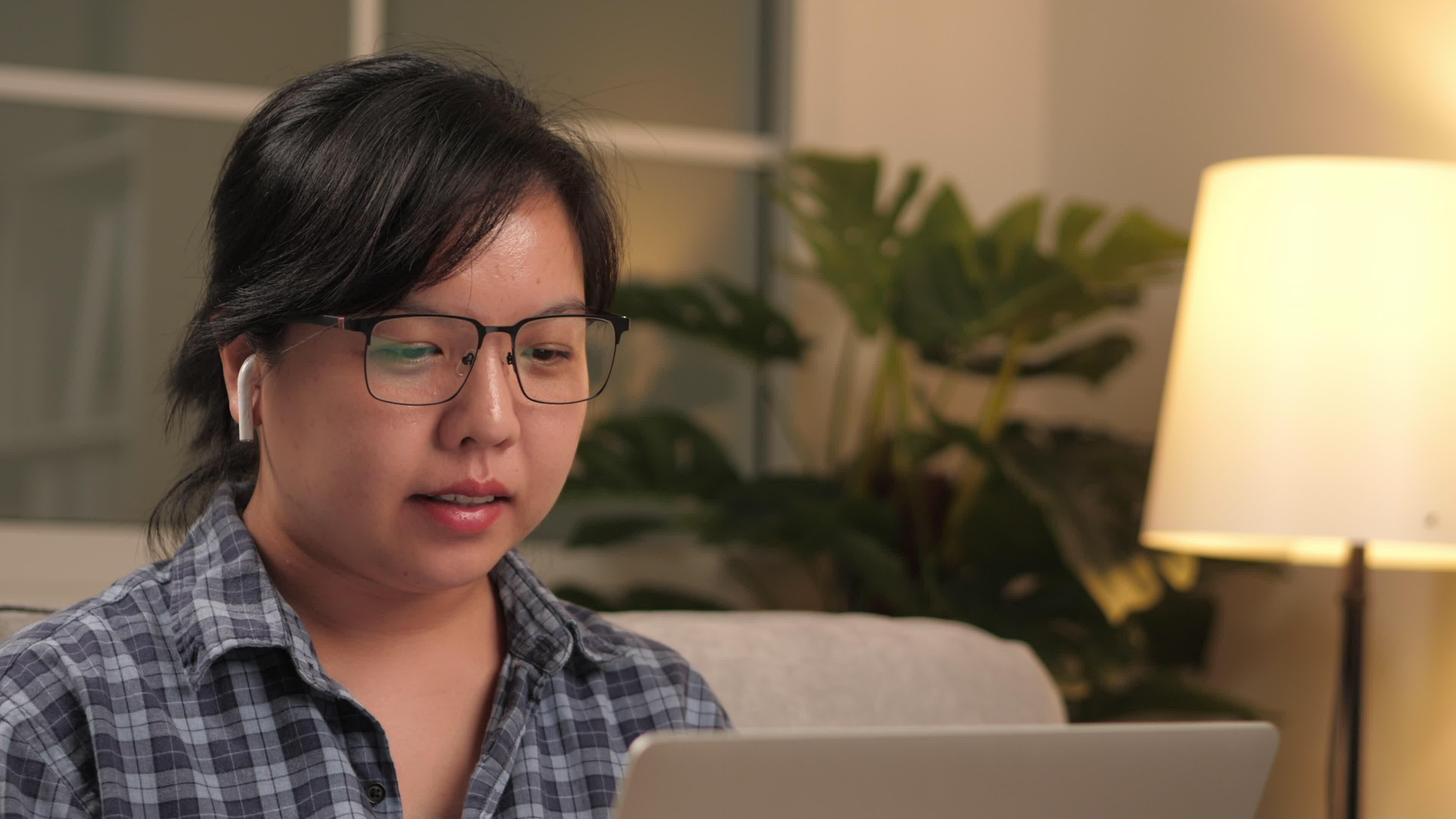 Footage of youngAsian businesswoman using an app on pc for Footage of youngAsian businesswoman using an app on pc for
