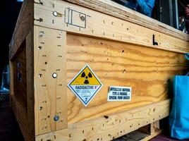 Radiation label beside the transport wooden box Type A package photo