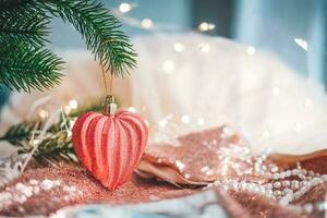 Christmas balls, in the form of a heart on a Christmas tree with a garland. Happy New Year . Christmas ball. Copy space photo