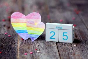 Rainbow Flag Day. Calendar with date 25 June and a heart with a rainbow painted in the color of the lgbt flag. photo