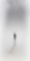 there is a man walking in the fog with an umbrella. . photo