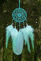 Handmade dream catcher with feathers threads and beads rope hanging photo