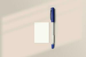 Realistic A8 paper flatlay mockup with a pen. Portrait A8 International Paper Size mockup top view. Simple, clean, modern, minimal super small paper mock up flat lay concept photo