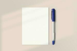 Realistic A6 paper flatlay mockup with a pen. Portrait A6 International Paper Size mockup top view. Simple, clean, modern, minimal small paper mock up flat lay concept photo