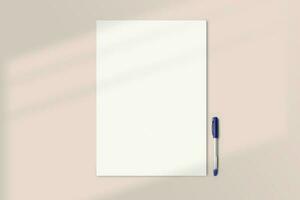 Realistic A3 paper flatlay mockup with a pen. Portrait big paper A3 International Paper Size mockup top view. Simple, clean, modern, minimal poster mock up flat lay concept photo