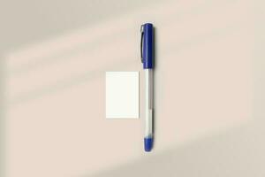 Realistic A9 paper flatlay mockup with a pen. Portrait A9 International Paper Size mockup top view. Simple, clean, modern, minimal super small paper mock up flat lay concept photo