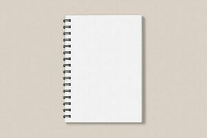 Realistic spiral notebook blank cover mockup flatlay. Simple blank note book mock up on clean background top view. White empty notepad cover to place your design, flat lay concept photo