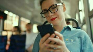 Öffentlichkeit Transport. Frau im Brille im Straßenbahn mit Smartphone. video