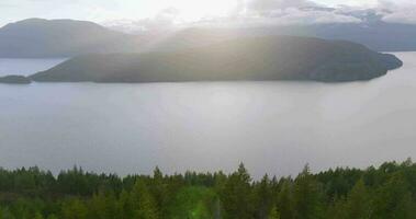 Aerial view of Harrison Lake and forest with mountain range in background video