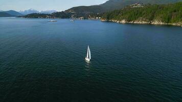 Aerial view of a boat sailing along the coast at sunset. video