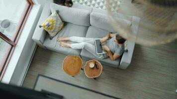 Overhead shot of woman using laptop at home video