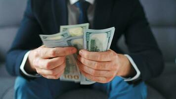 Formally dressed man counting US Dollar bills, close-up. video