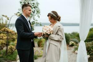 wedding ceremony of the newlyweds in a country cottage photo