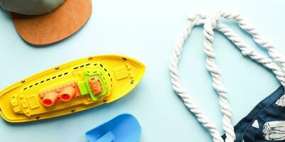 Banner flat lay beach on a blue background. Childrens beach toys. Beach bag photo