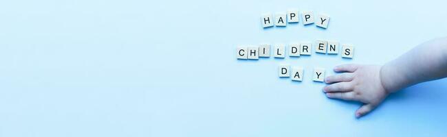 Banner Flat lay happy childrens day on blue background. Childrens hand. Children Protection Day photo