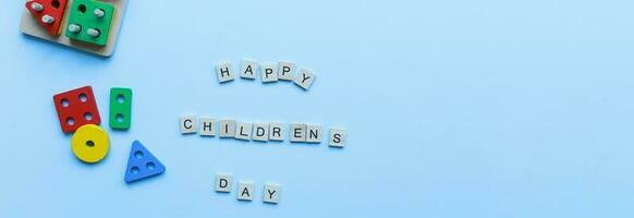 Banner Flat lay happy children is day on blue background. Kids toys. Children is sorter. photo