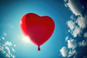 Red balloon in heart shape flying on the air with blue sky background. Valentines day concept. photo