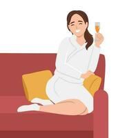 Young beautiful smiling woman sitting with bent legs on a large white comfortable sofa with cup of tea or drink, white bathrobe. Girl in the spa. Beauty treatments and relaxation. vector