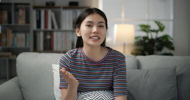 Portrait of young asian female blogger smiling face talking to webcam recording vlog photo