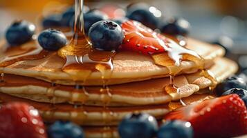 Delicious pancakes, with fresh blueberries, strawberries and maple syrup Illustration photo