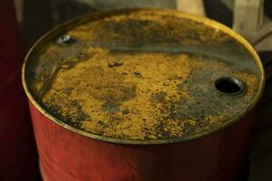 Fuel barrel with yellow lid. Red fuel tank. Old canister. photo