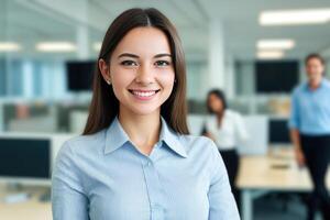 Young smiling businesswoman, standing in blur background of office. photo