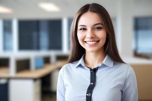 Young smiling businesswoman, standing in blur background of office. photo