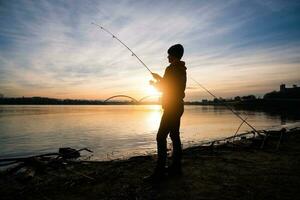 A boy is fishing on a sunny day photo