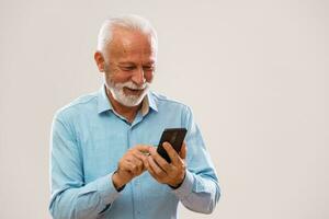 Senior man holding a phone photo