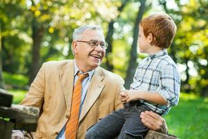 A grandfather and his grandson spending time together outdoors photo