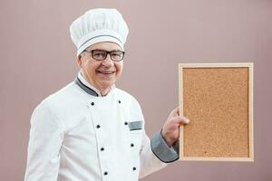 A chef pointing to a display photo