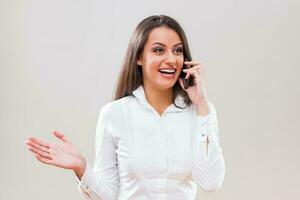 A woman with a white shirt on the phone photo