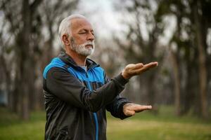 A senior man doing physical exercises photo