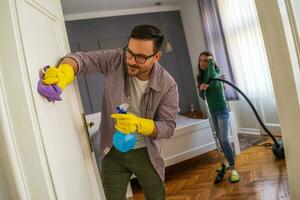 Young couple is cleaning their apartment photo