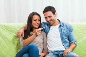 Portrait of a young couple with a pregnancy test photo