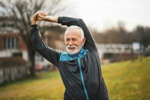 A senior man doing physical exercises photo